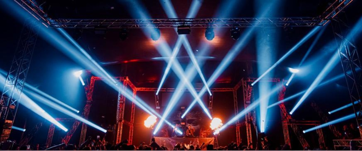 DJ performance with spectacular light show and flames on large stage